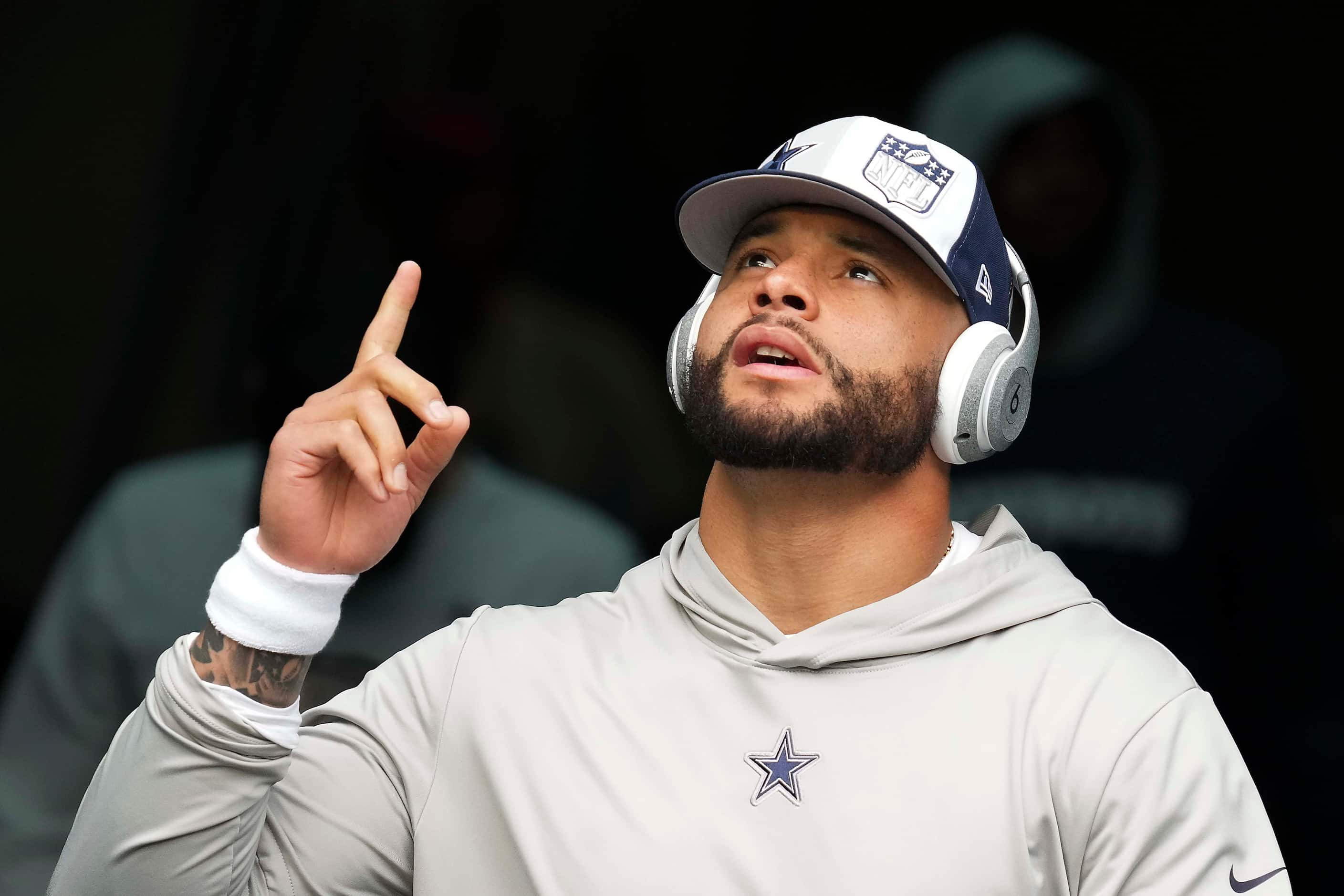 Dallas Cowboys quarterback Dak Prescott  takes the field to warm up before an NFL football...