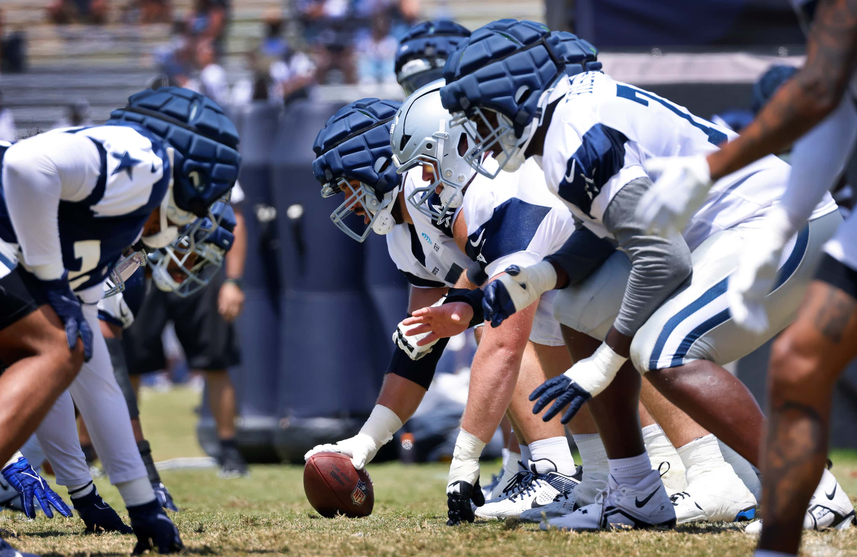 The Dallas Cowboys offensive line lines up against the defensive line during a training camp...