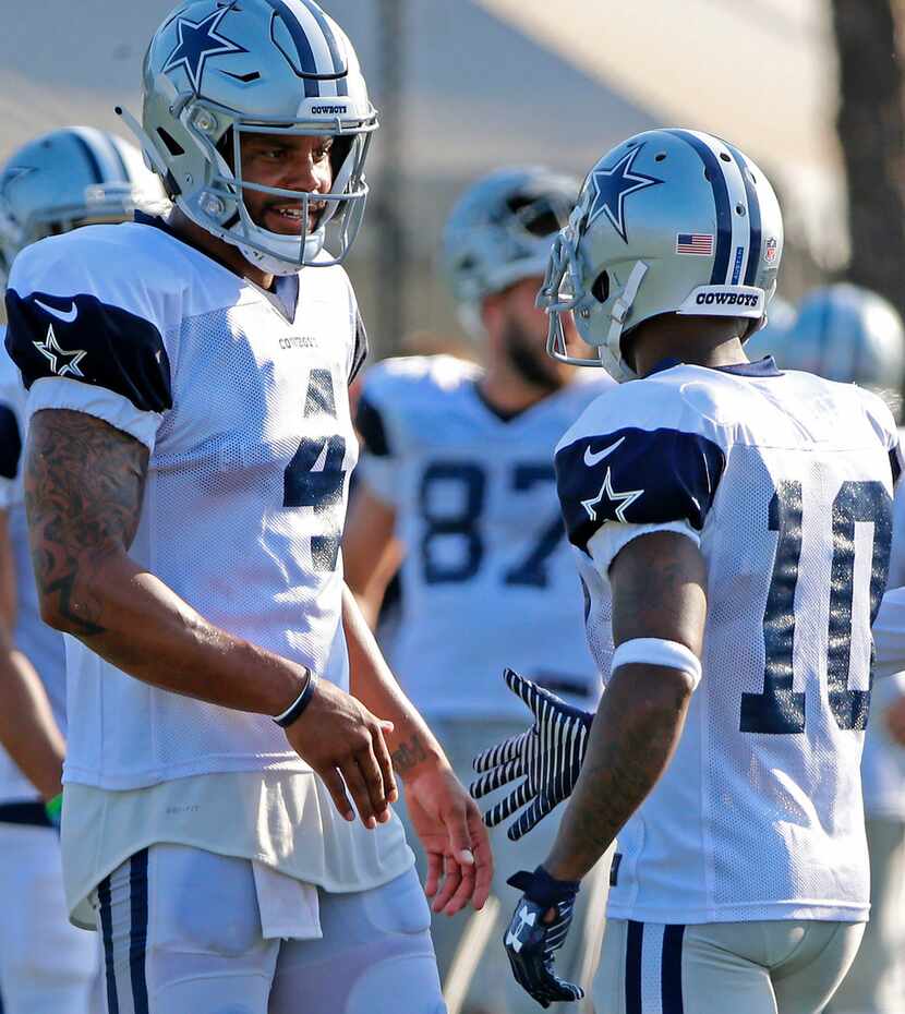 Dallas Cowboys wide receiver Tavon Austin (10, right) shakes hands with quarterback Dak...