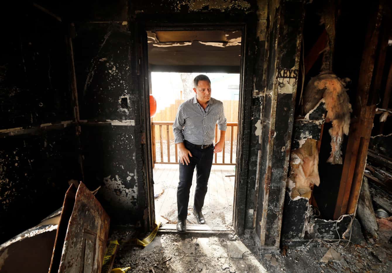 Rep. Rafael Anchia steps inside a house on Durango Drive in Dallas that burned in a fire...