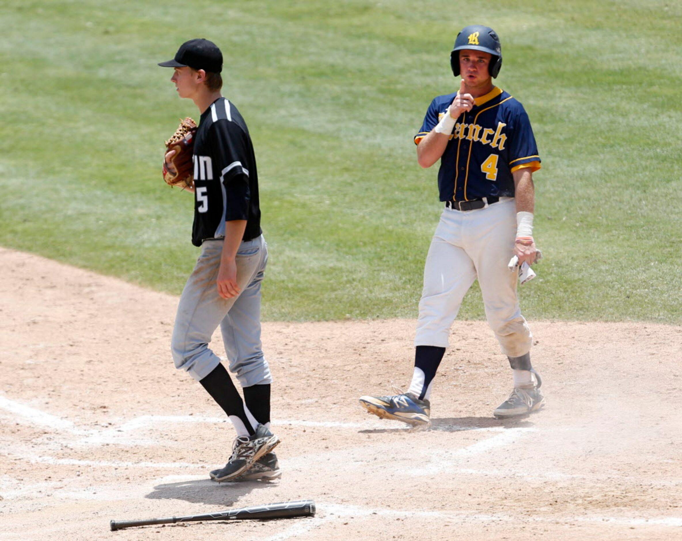 Cypress Ranch's Hayden Evans (4) signals back toward the Arlington Martin crowd after...