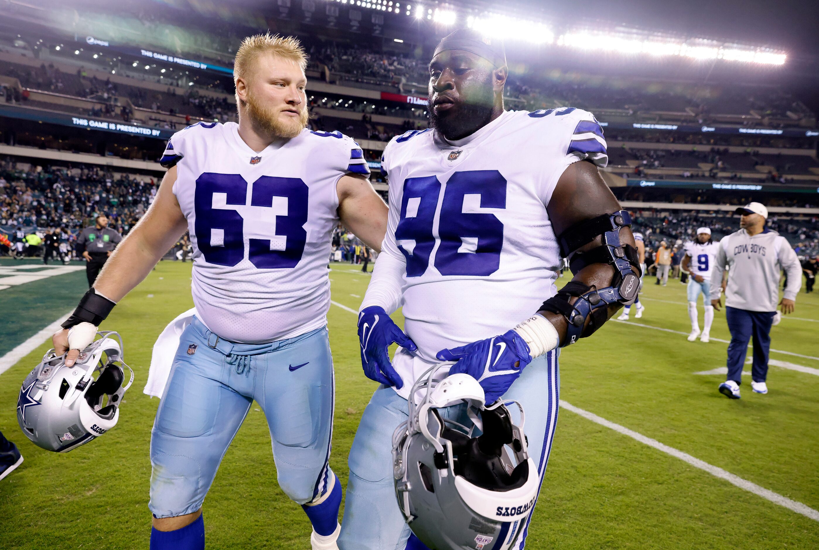 Dallas Cowboys center Tyler Biadasz (63) runs off the field as he taps defensive tackle...