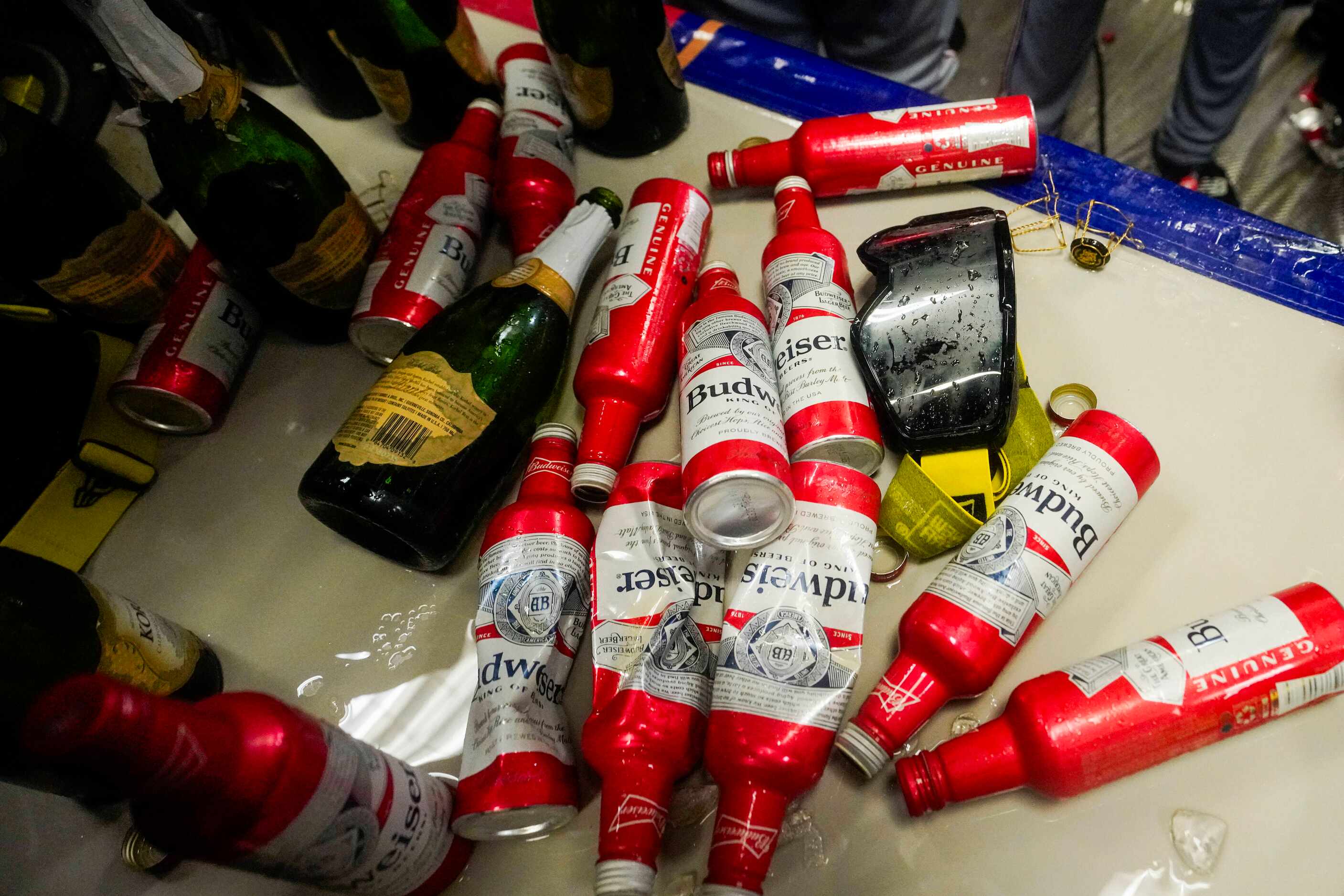 Empty bottles on a tables as Texas Rangers players celebrate in the clubhouse after...