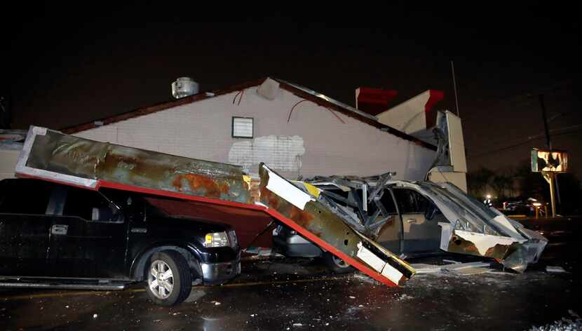 The roof of the drive-thru at the Burger Box restaurant on Cooper St. in Arlington trapped...