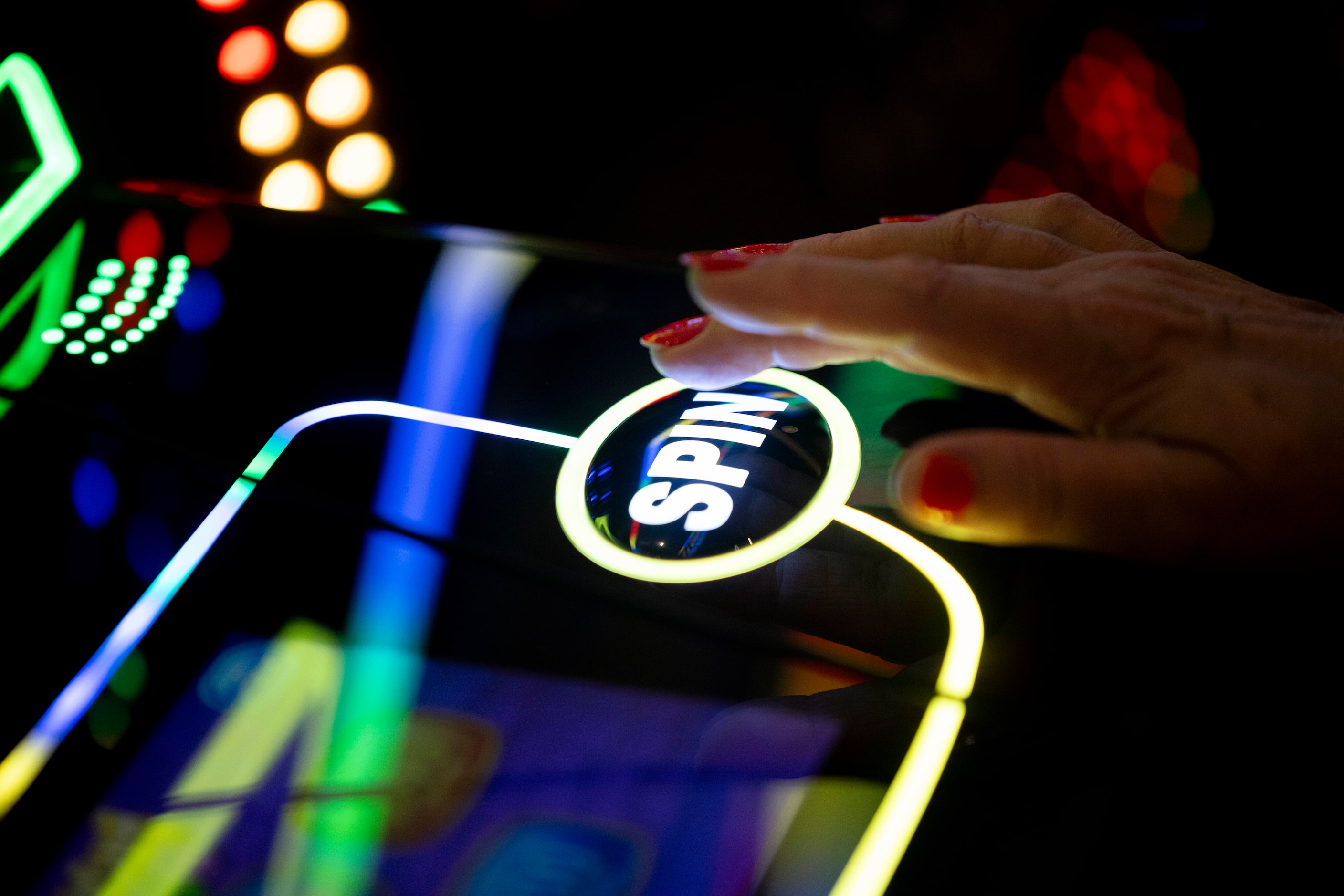 Cheryl Baden of Oklahoma pushes the spin button on a slot machine at Choctaw Landing on...