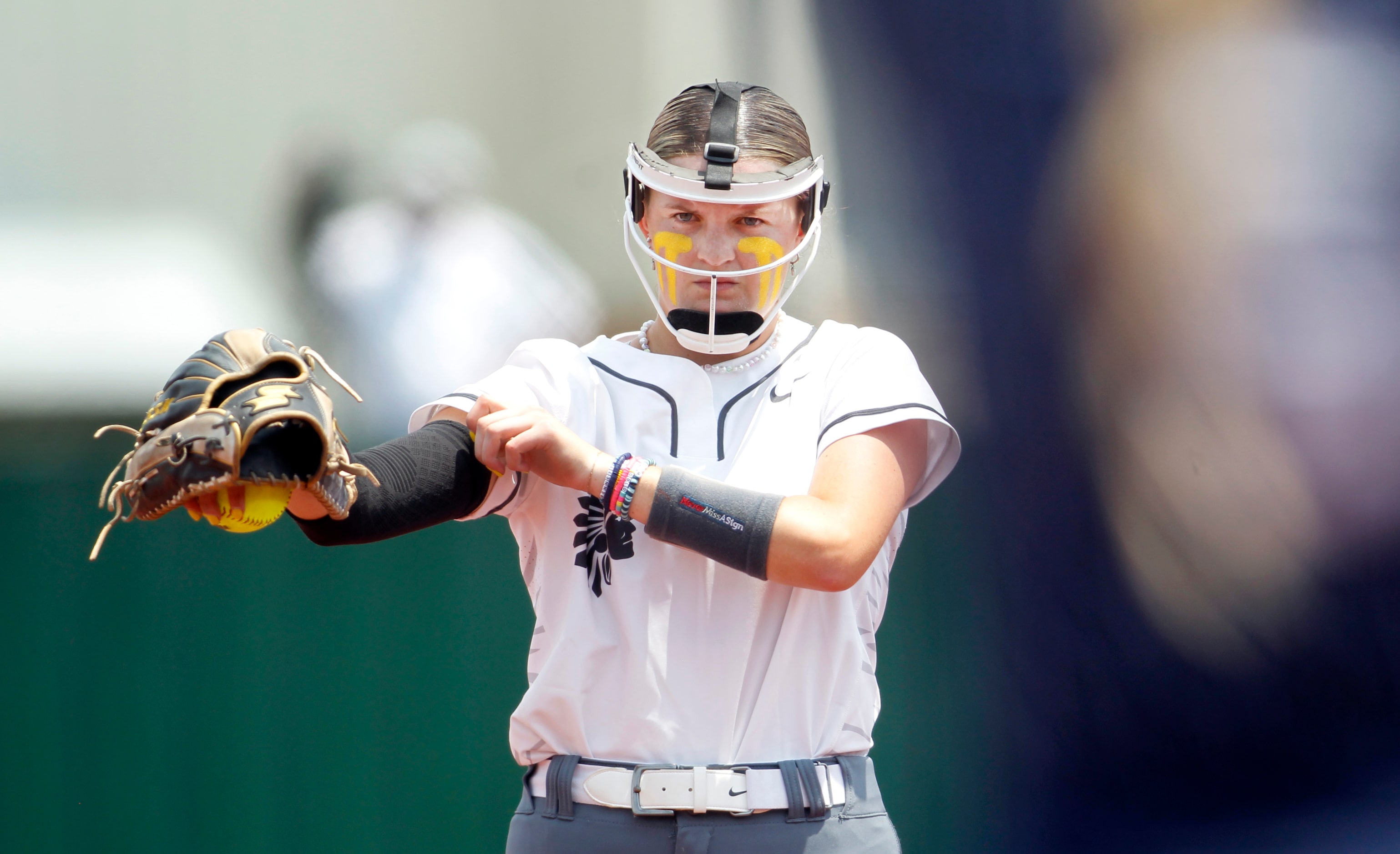 Keller pitcher Sadie Beck (7) adjusts a flexible sleeve on her throwing forearm before...