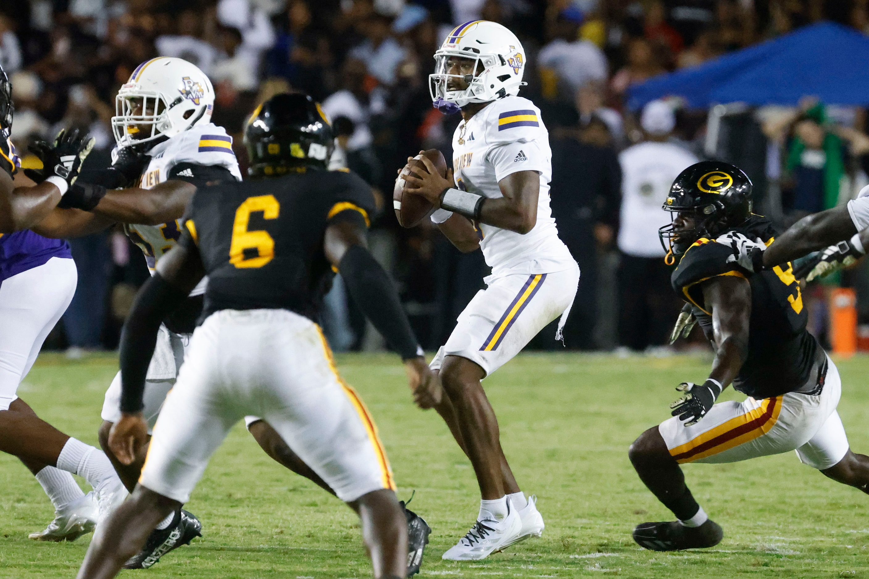 Prairie View A&M quarterback Jaden Johnson (center) looks to throw during the second half of...