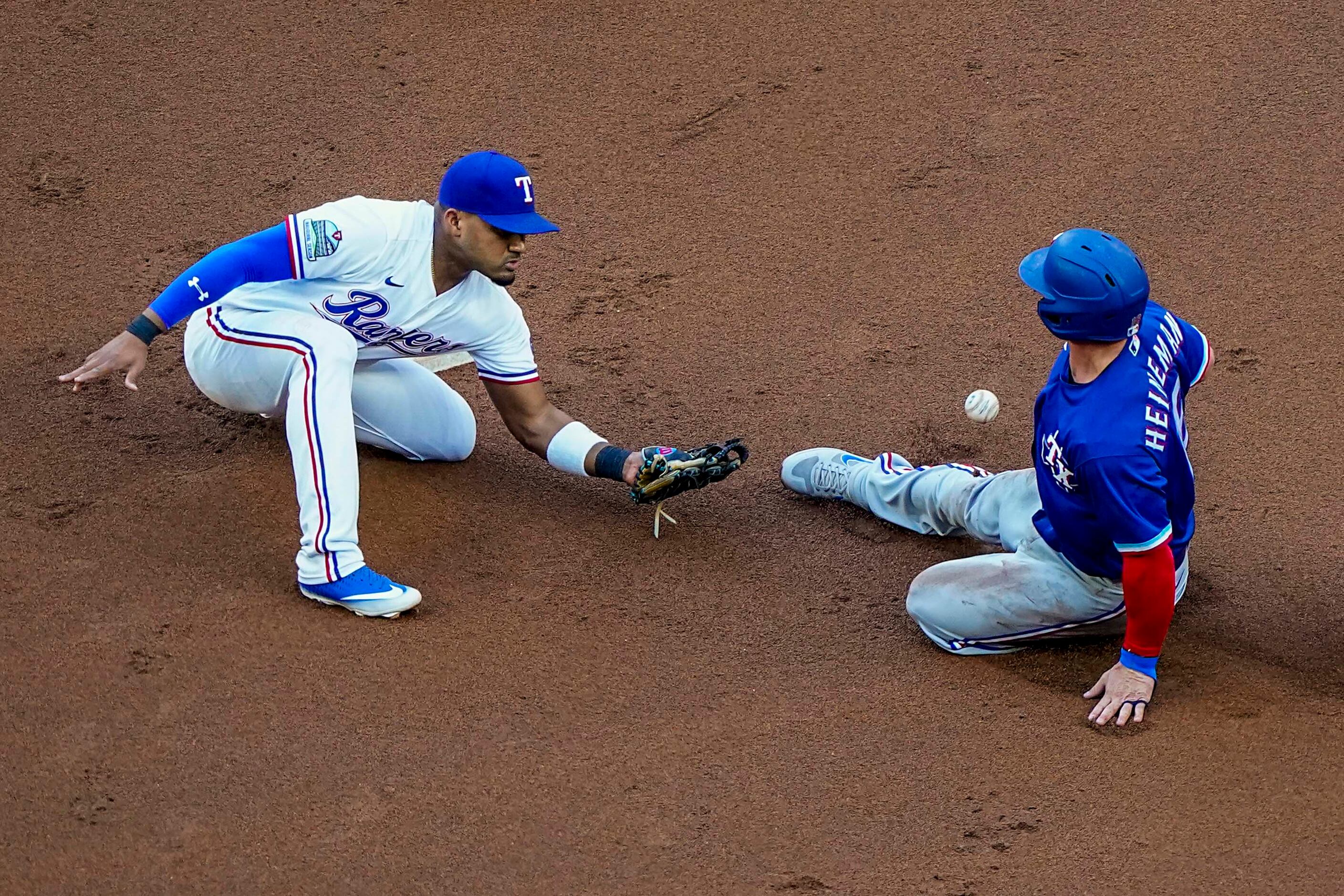 Outfielder Scott Heineman is safe on a stolen base attempt as the ball gets away from...