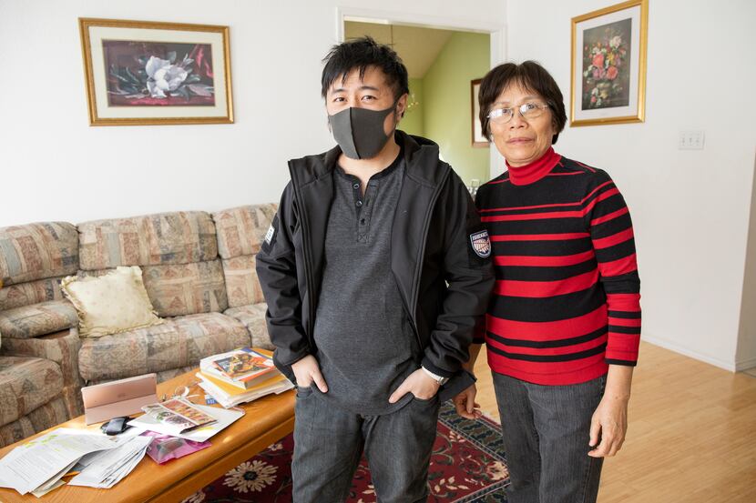 Warren Lee and his mother, Sho Lee, pose for a photo at home in Euless on Thursday . After...