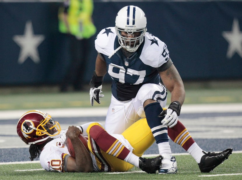 Dallas Cowboys defensive end Jason Hatcher (97) sacks Washington Redskins quarterback Robert...