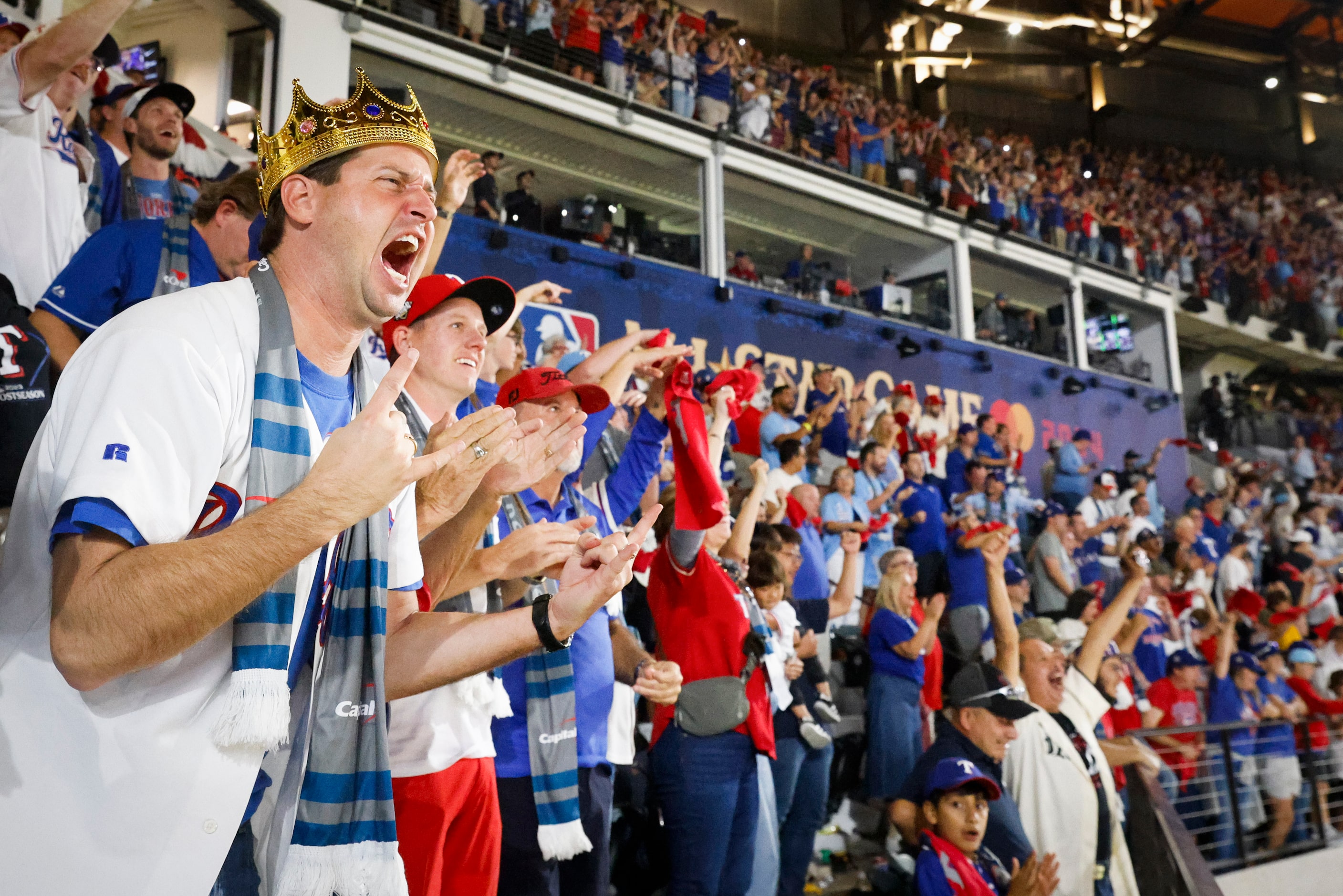 Texas Rangers fans including Richard C. White (left) celebrate after Corey Seager hit...