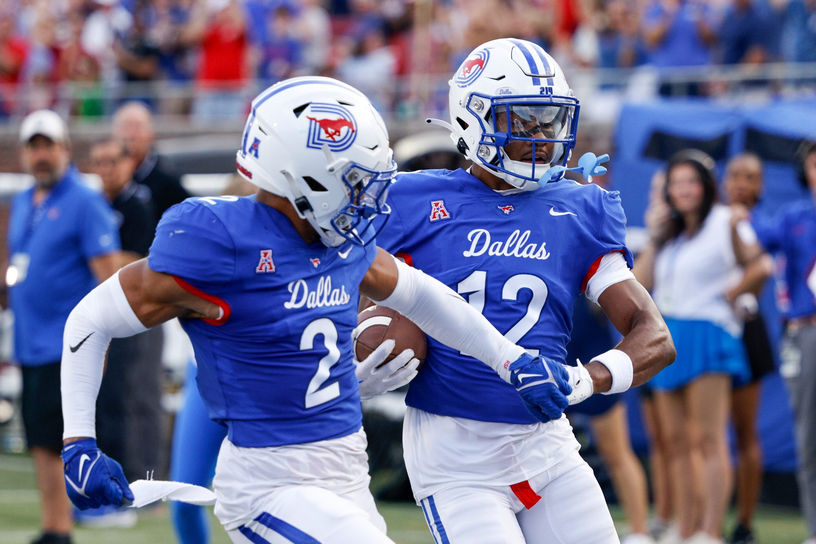 SMU cornerback Chris Megginson (12) holds hands with SMU safety Jonathan McGill (2) as he...