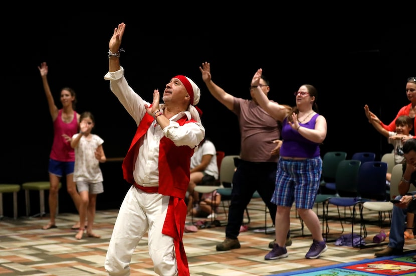 Eduardo Gutierrez with Ollimpaxqui Ballet Company teaches audience members a dance at the...