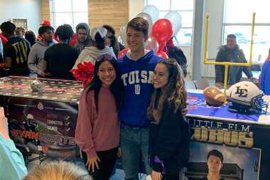 Little Elm kicker Tyler Tipton poses with friends after signing his National Letter of...