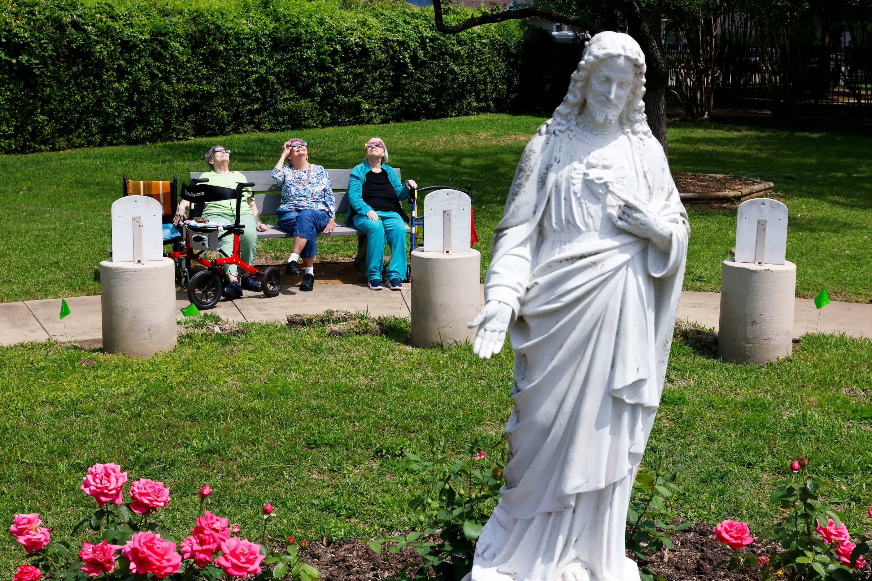 From left, Judy Green, Elizabeth Hobbs, and Patricia Head, look up as they enjoy the view of...