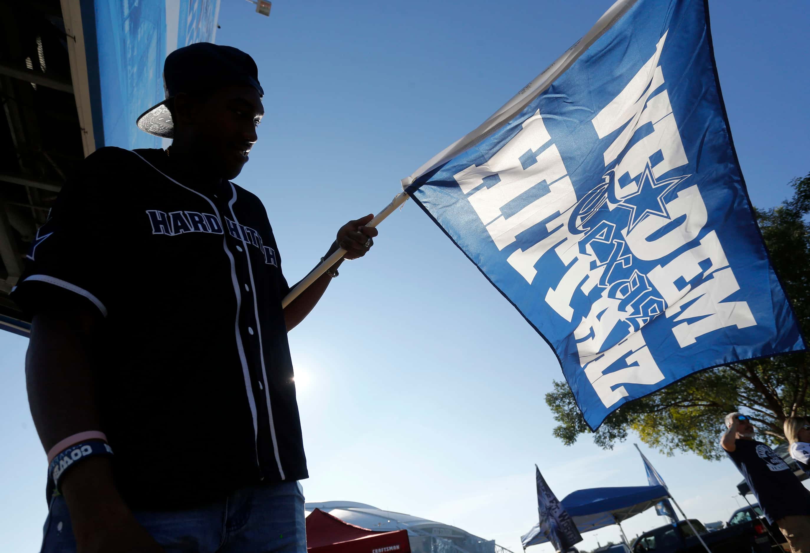 Dallas Cowboys fan Louie Boie, of Dallas, holds his “We Dem Texas Hittahz” flag up on the...