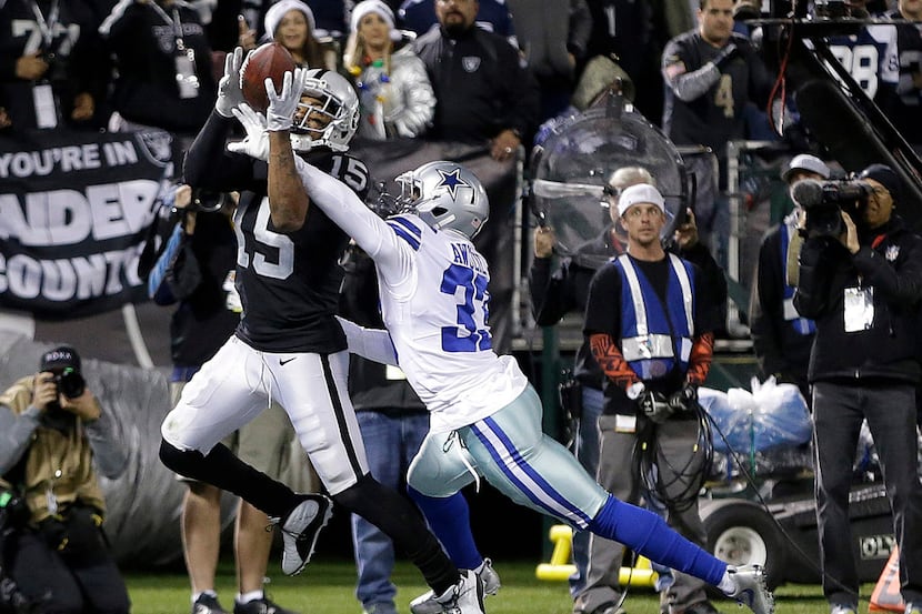 Oakland Raiders wide receiver Michael Crabtree (15) catches a touchdown pass in front of...