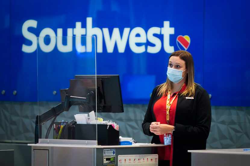 A Southwest Airlines agent works at a check-in counter at Love Field in Dallas.