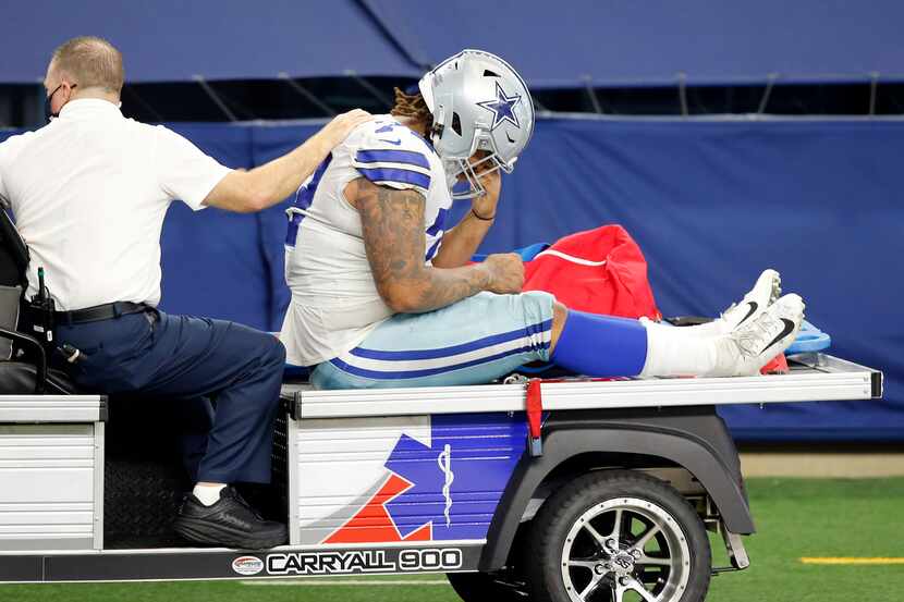 Dallas Cowboys defensive tackle Trysten Hill (72) is carted off the field after sustaining...