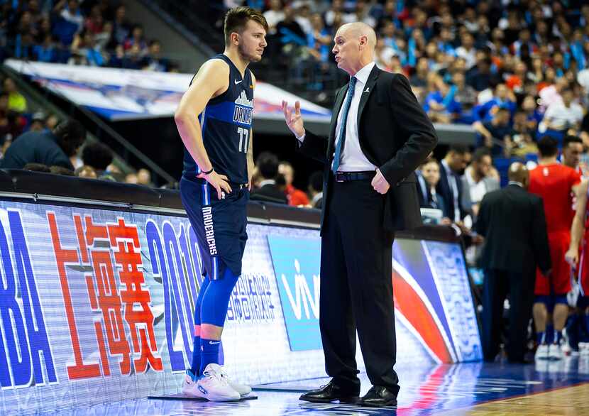 Dallas Mavericks guard Luka Doncic (77) talks with head coach Rick Carlisle before checking...