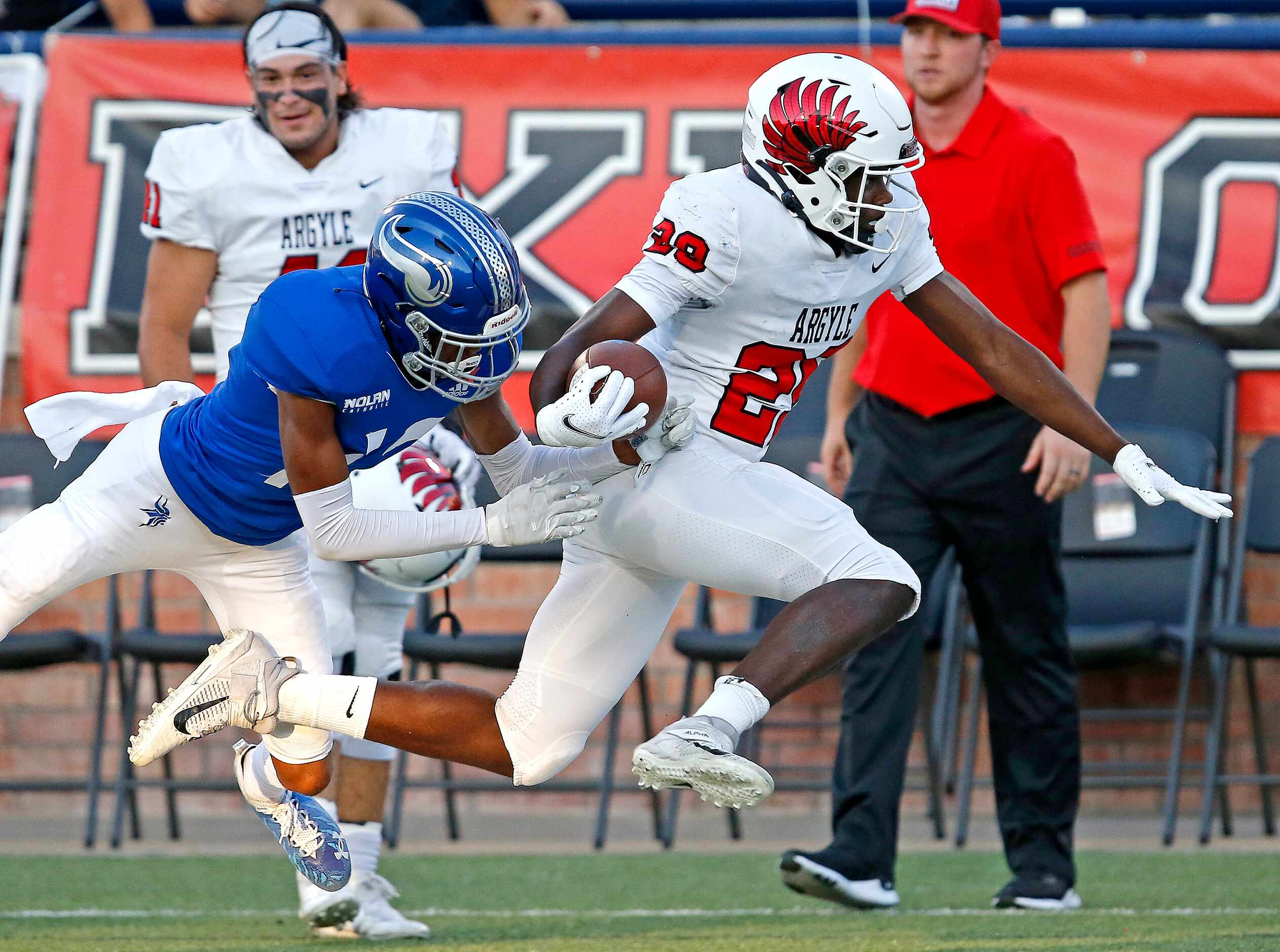 Argyle High School wide receiver Jaamael Felton (29) is shoved out of bound by Nolan...
