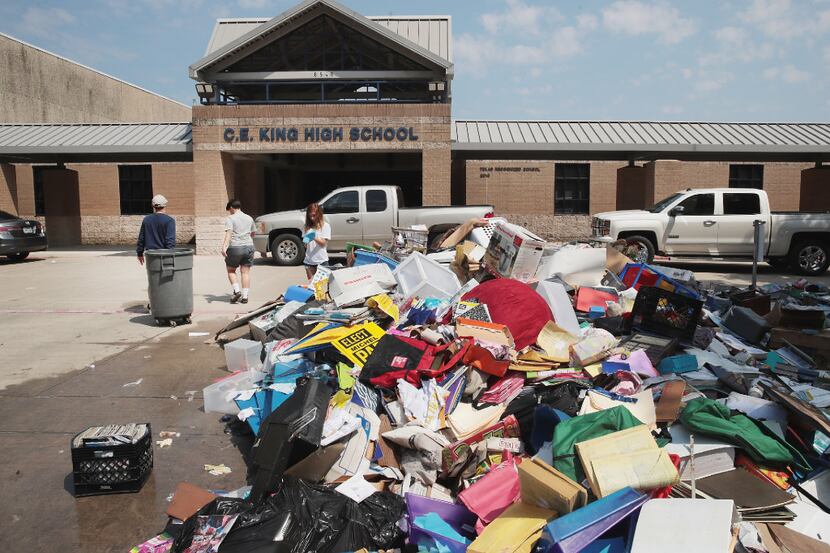 Volunteers and students from C.E. King High School helped to clean up the school Friday...