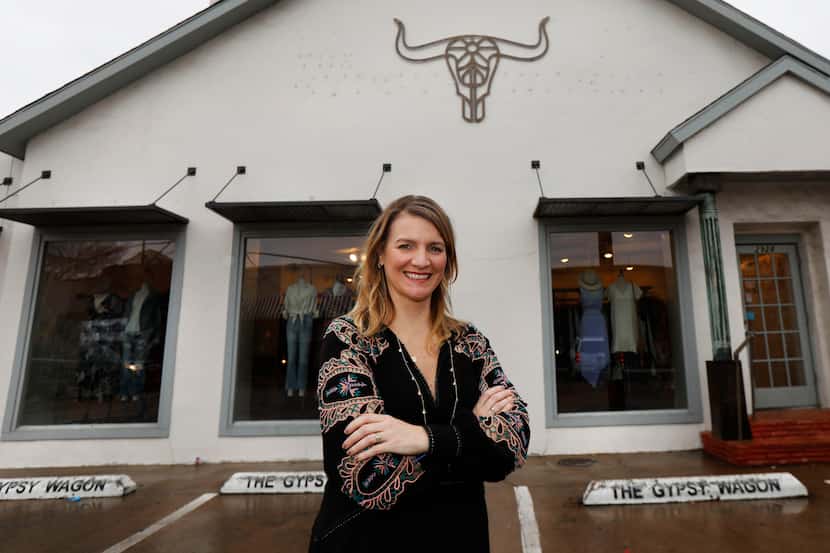 Carley Seale stands outside her North Henderson Avenue shop on Tuesday, after the lettering...