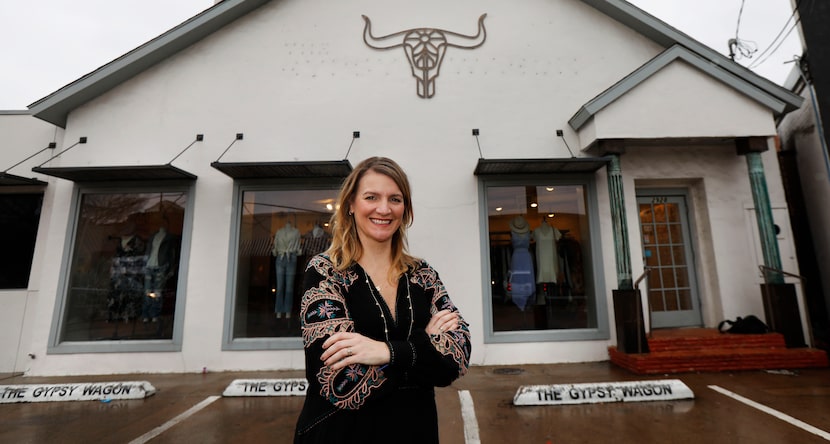 Carley Seale stands outside her North Henderson Avenue shop on Tuesday, after the lettering...