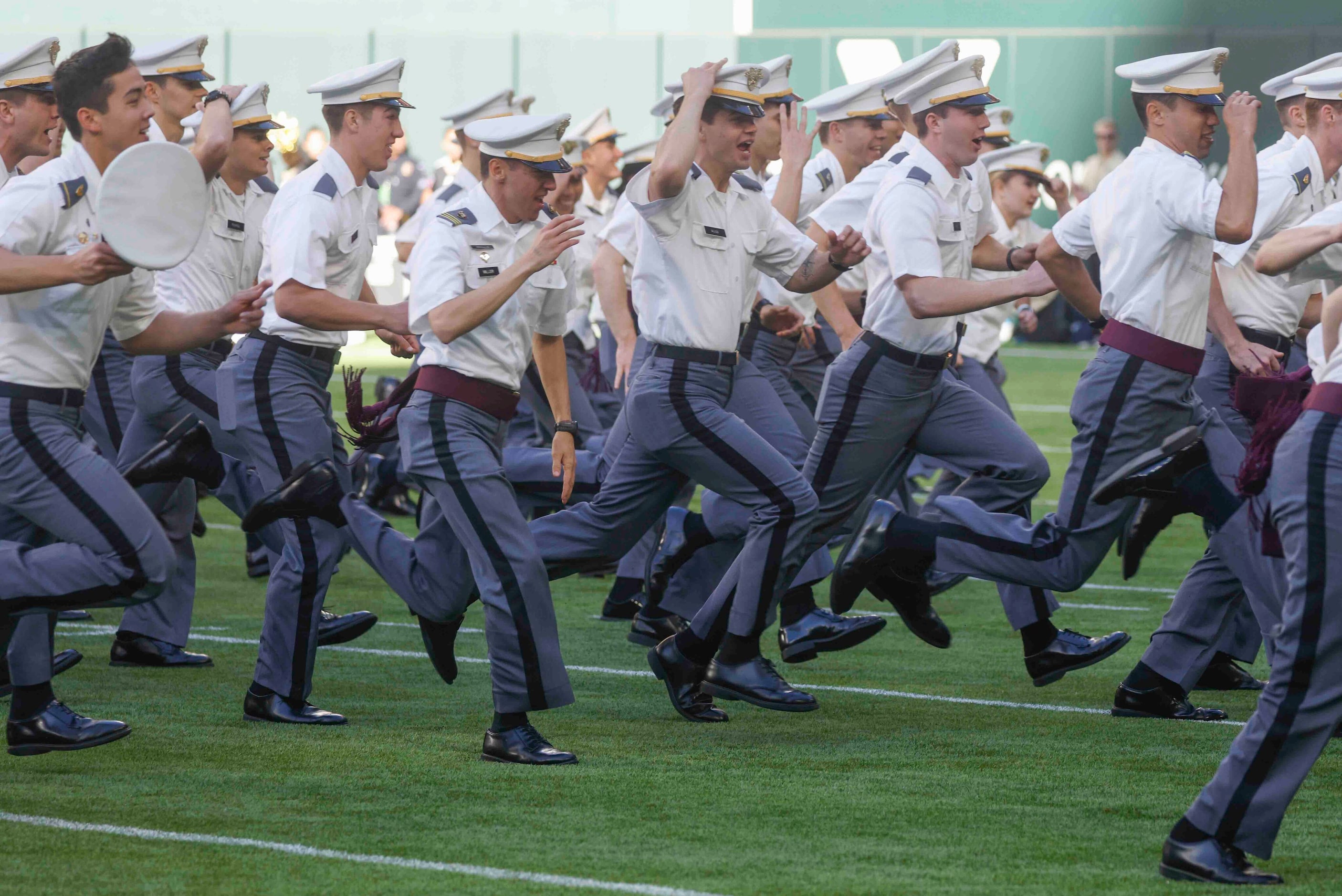 Army cadets run to exit the field ahead of an NCAA football game between Army and Air Force...