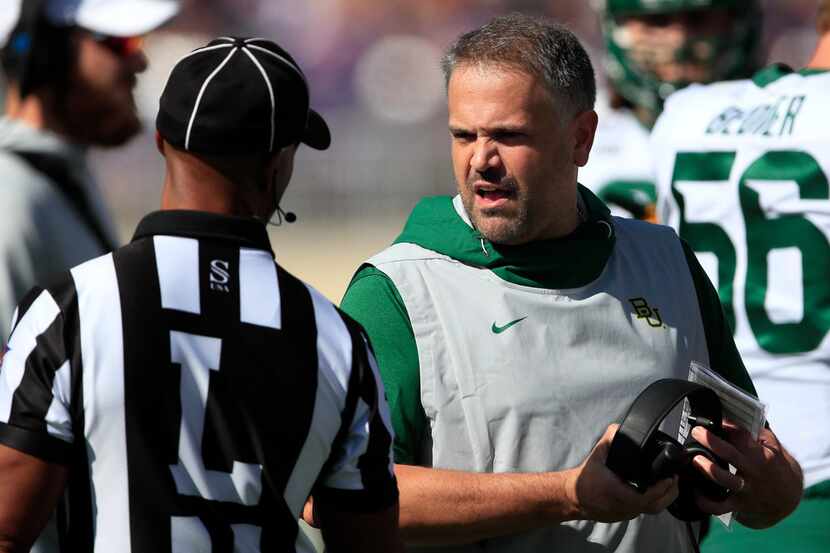 Baylor head coach Matt Rhule, right, talks with line judge Quentin Givens, left, during the...