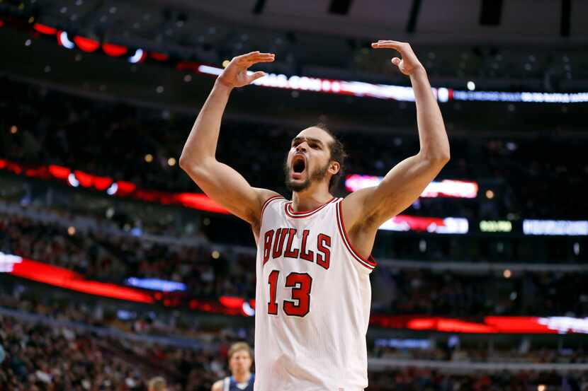 Chicago Bulls center Joakim Noah gestures toward the crowd during the second half of an NBA...