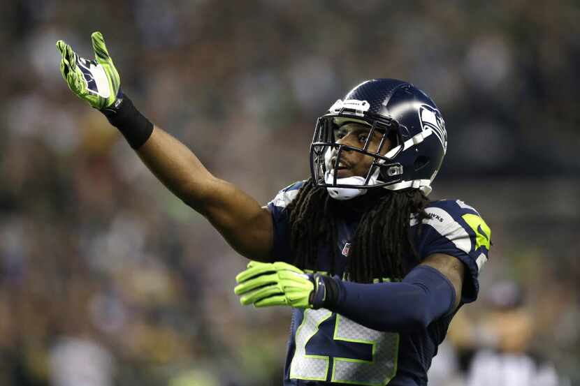 Seattle Seahawks cornerback Richard Sherman gestures to the crowd in the second half of an...