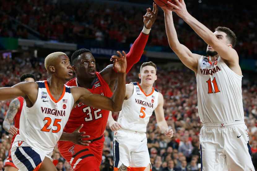 Virginia Cavaliers guard Ty Jerome (11) grabs a rebound in front of Texas Tech Red Raiders...