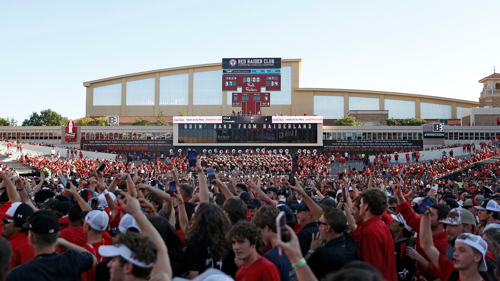 Texas Tech fans celebrate on the field after an NCAA college football game against Texas,...