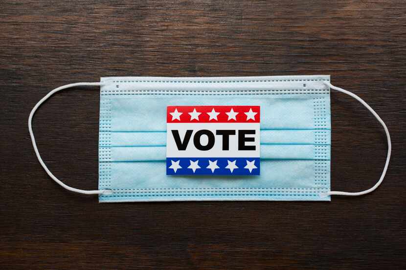 Vote sticker on face masks and american flags
