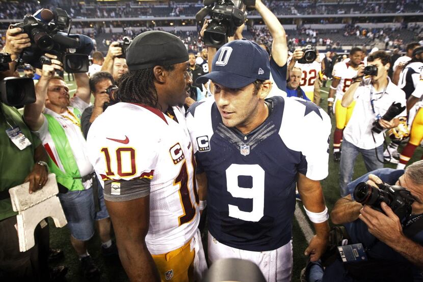 Washington Redskins quarterback Robert Griffin III  (10) talks to Dallas Cowboys quarterback...