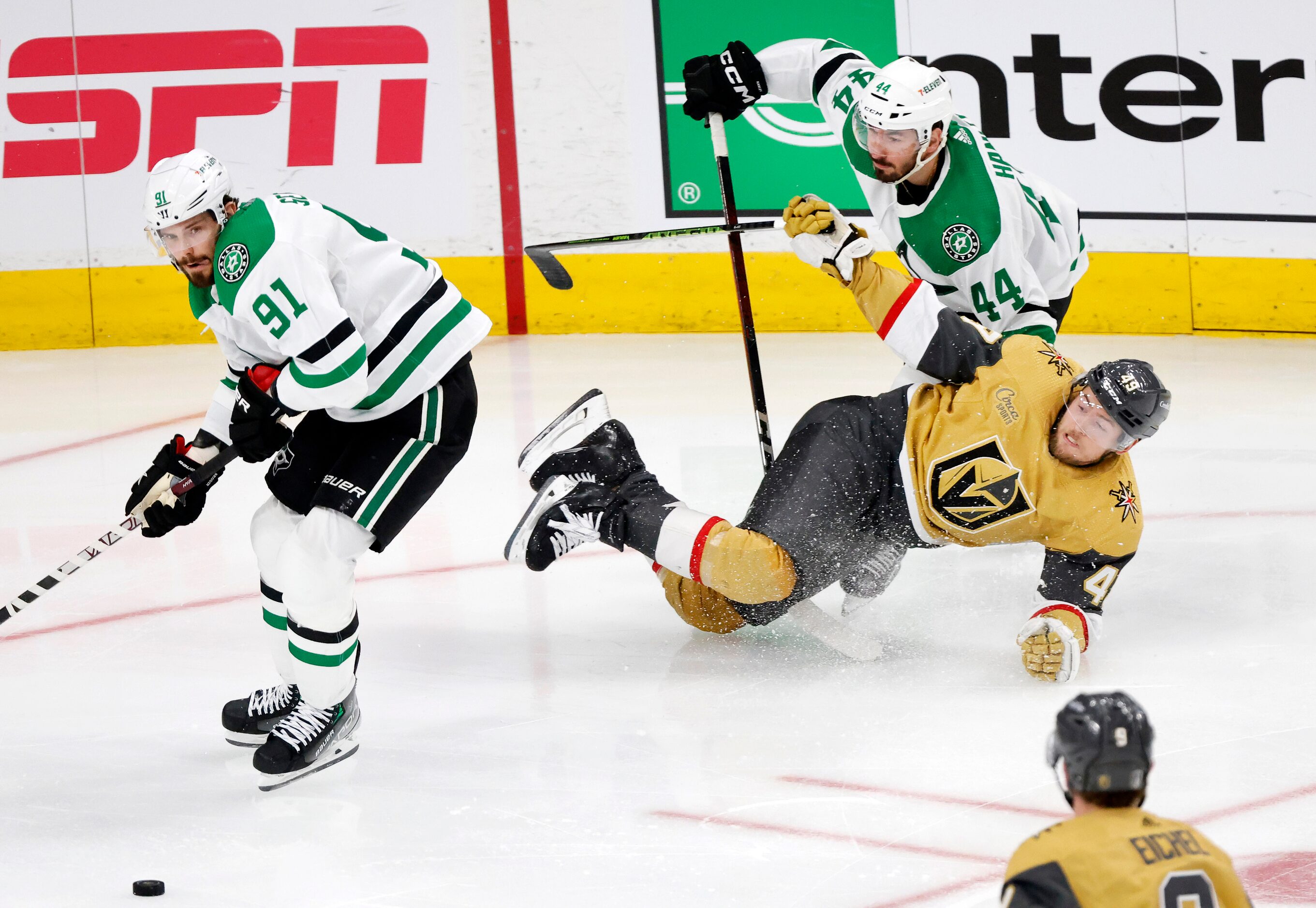 Vegas Golden Knights center Ivan Barbashev (49) is taken down by Dallas Stars defenseman...