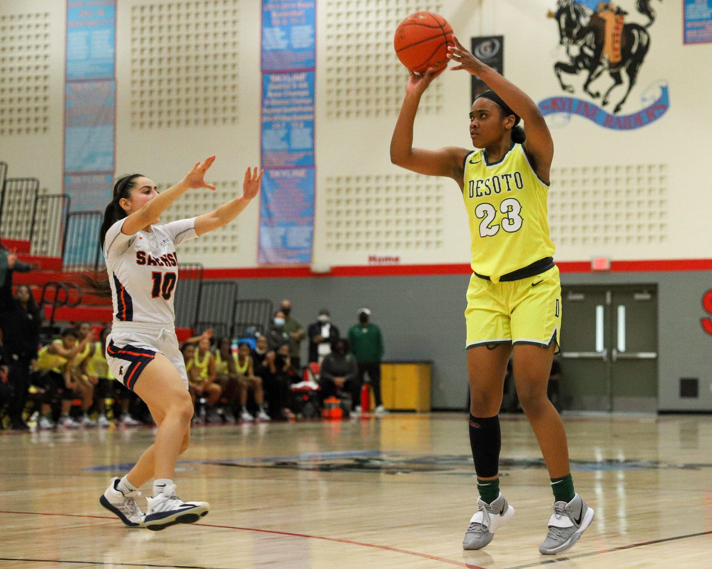 DeSoto’s Kendall Brown (23) shoots the ball over Sachse’s Brianna Salazar (10) during the...