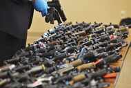 Dozens of recovered stolen handguns were shown at a news conference last November in Benton...