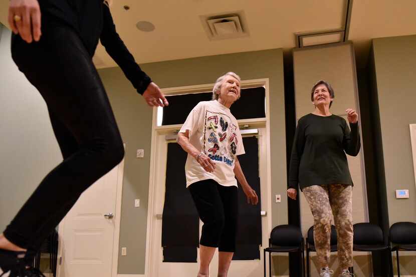 Coila Stevens (left) and Pam Spell, 77, sway to the music during a dance class with other...