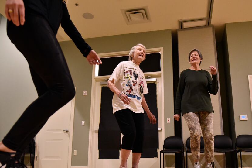 Coila Stevens (left) and Pam Spell, 77, sway to the music during a dance class with other...