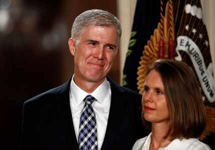 Judge Neil Gorsuch stands with his wife Louise as President Donald Trump speaks in the East...