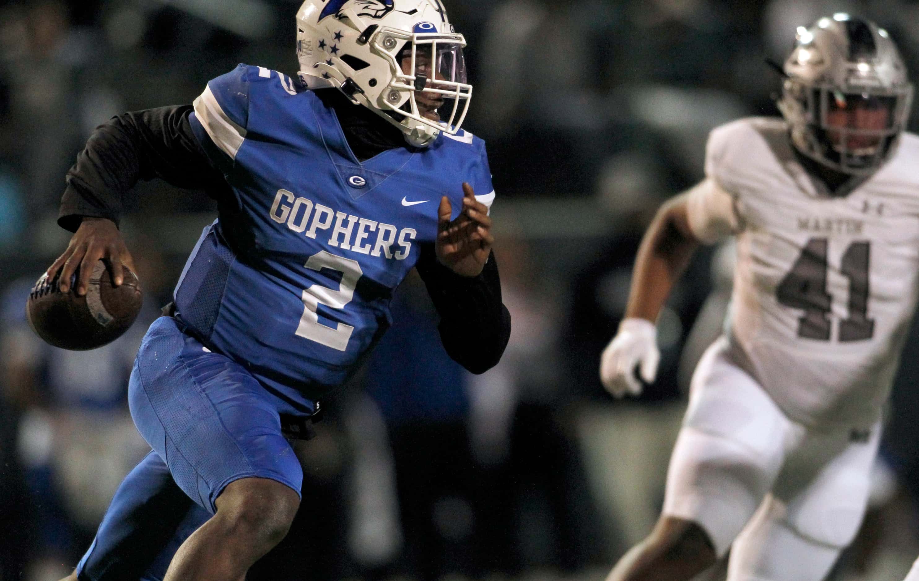 Grand Prairie quarterback Savion Red (2) looks for a receiver as he is pursued by Arlington...