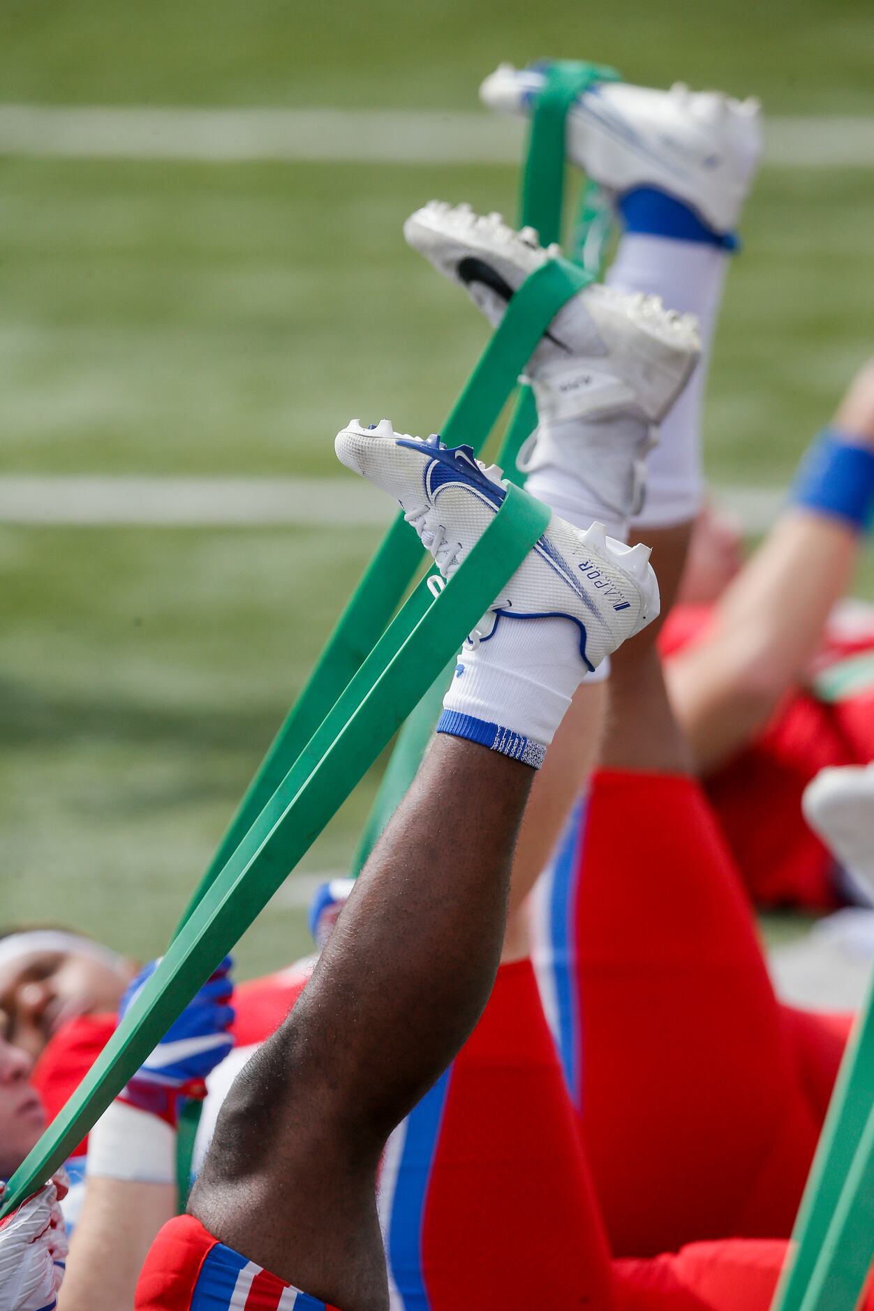 SMU football players stretch during practice at Gerald Ford Stadium, Saturday, April 17,...
