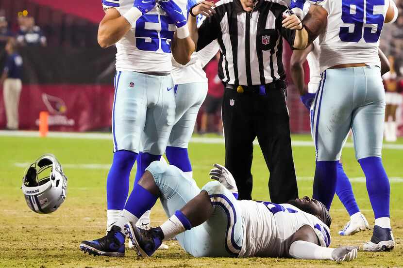 Dallas Cowboys defensive tackle Neville Gallimore (96) tosses away his helmet after being...