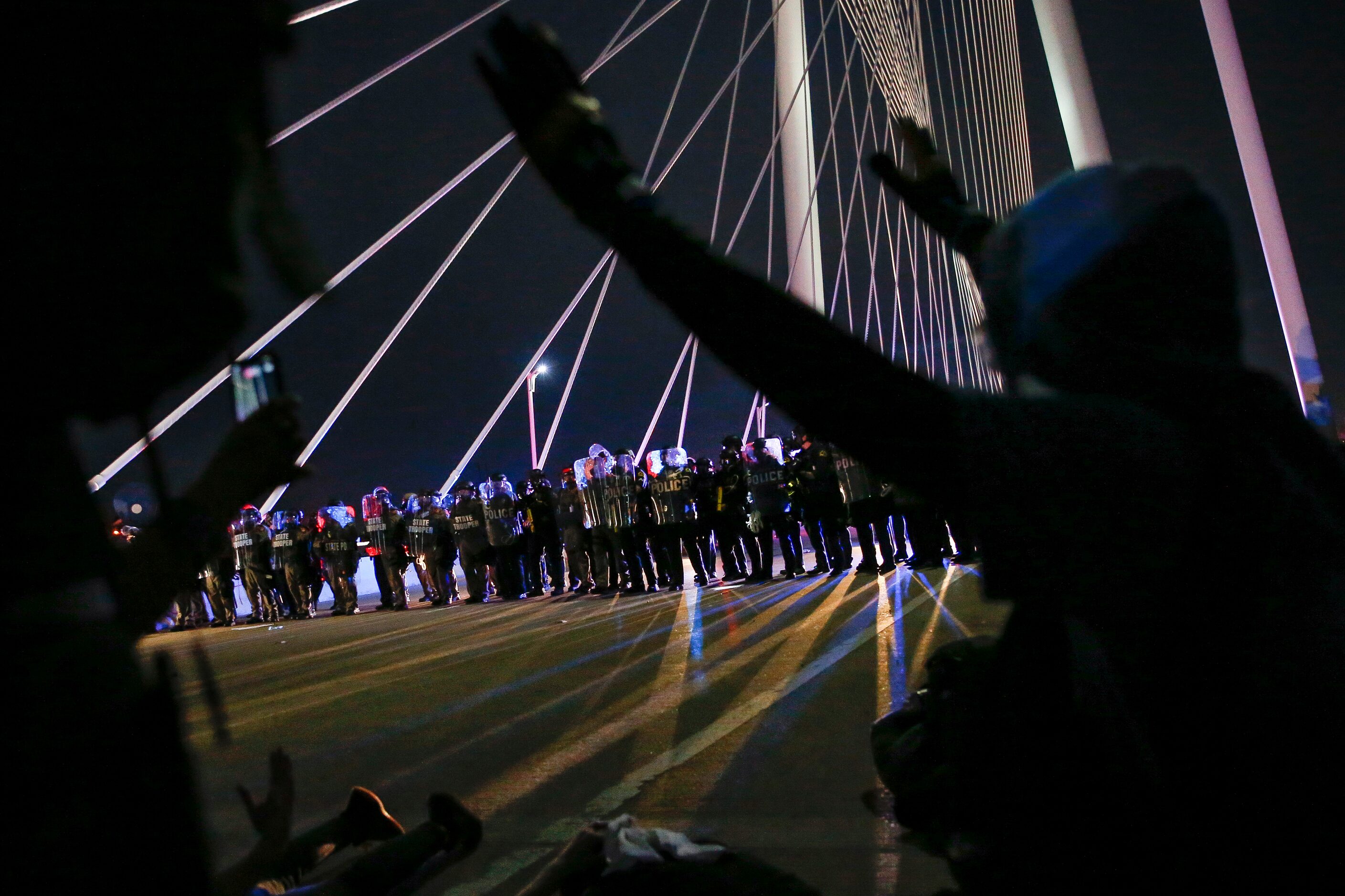 Police surround and detain hundreds of protesters who marched onto the Margaret Hunt Hill...