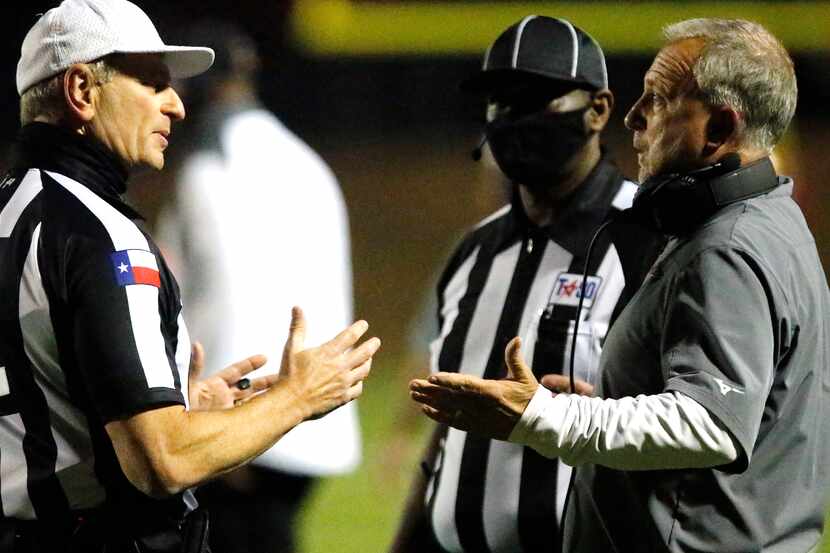 South Grand Prairie football coach Brent Whitson (right) talks with the referees during a...