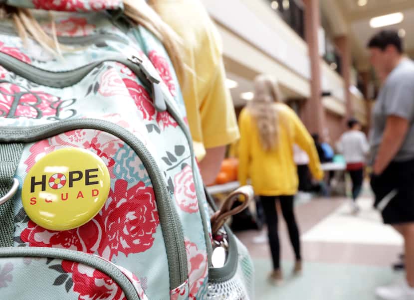 Hope Squad members display buttons on their backpacks to alert other students that they are...