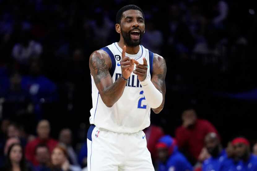 Dallas Mavericks' Kyrie Irving reacts during the first half of an NBA basketball game...