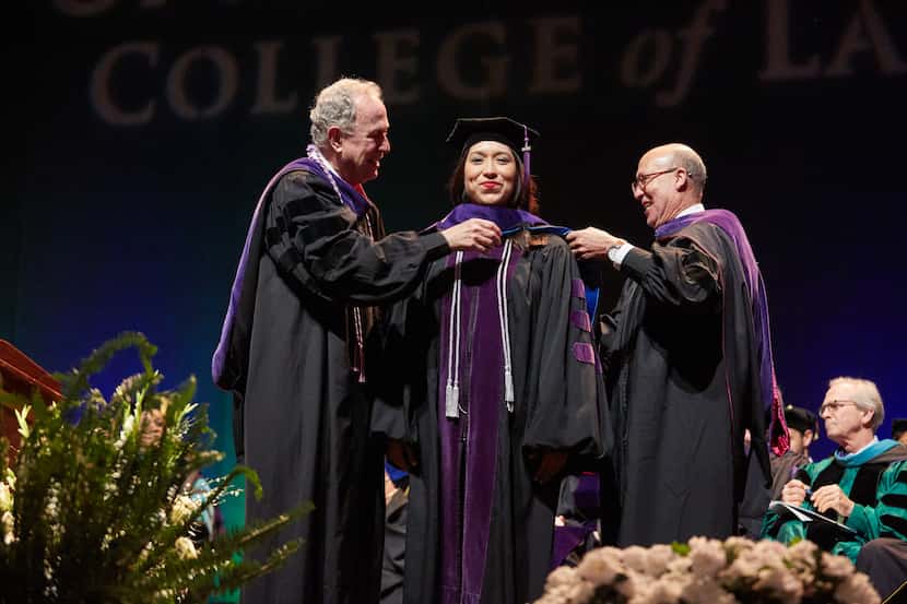 Dean Royal Furgeson of the University of North Texas Dallas College of Law, left, places an...